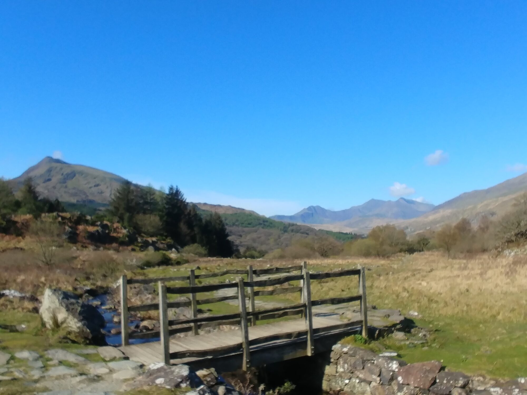 Bridge on mountain walk with Snowdon in the distance