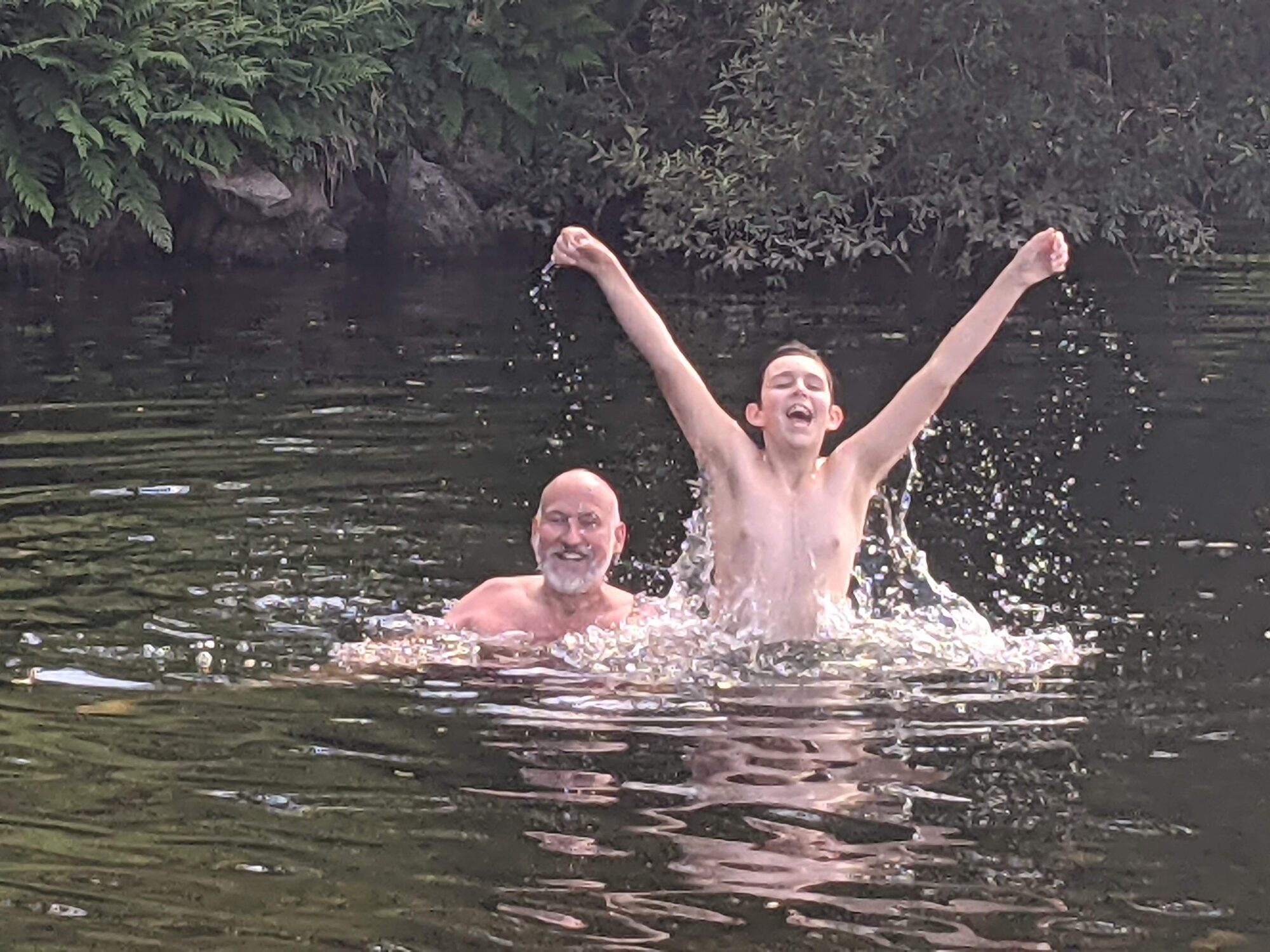 Man and boy wild swimming Afon Llygwy Capel Curig