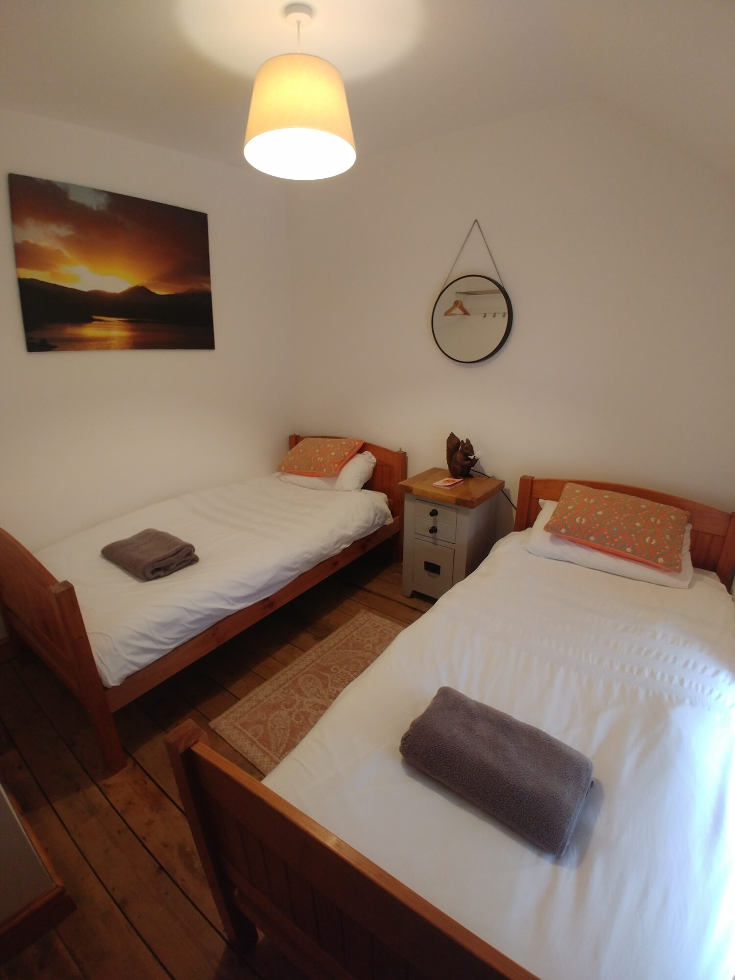 Twin bedroom with sunset picture