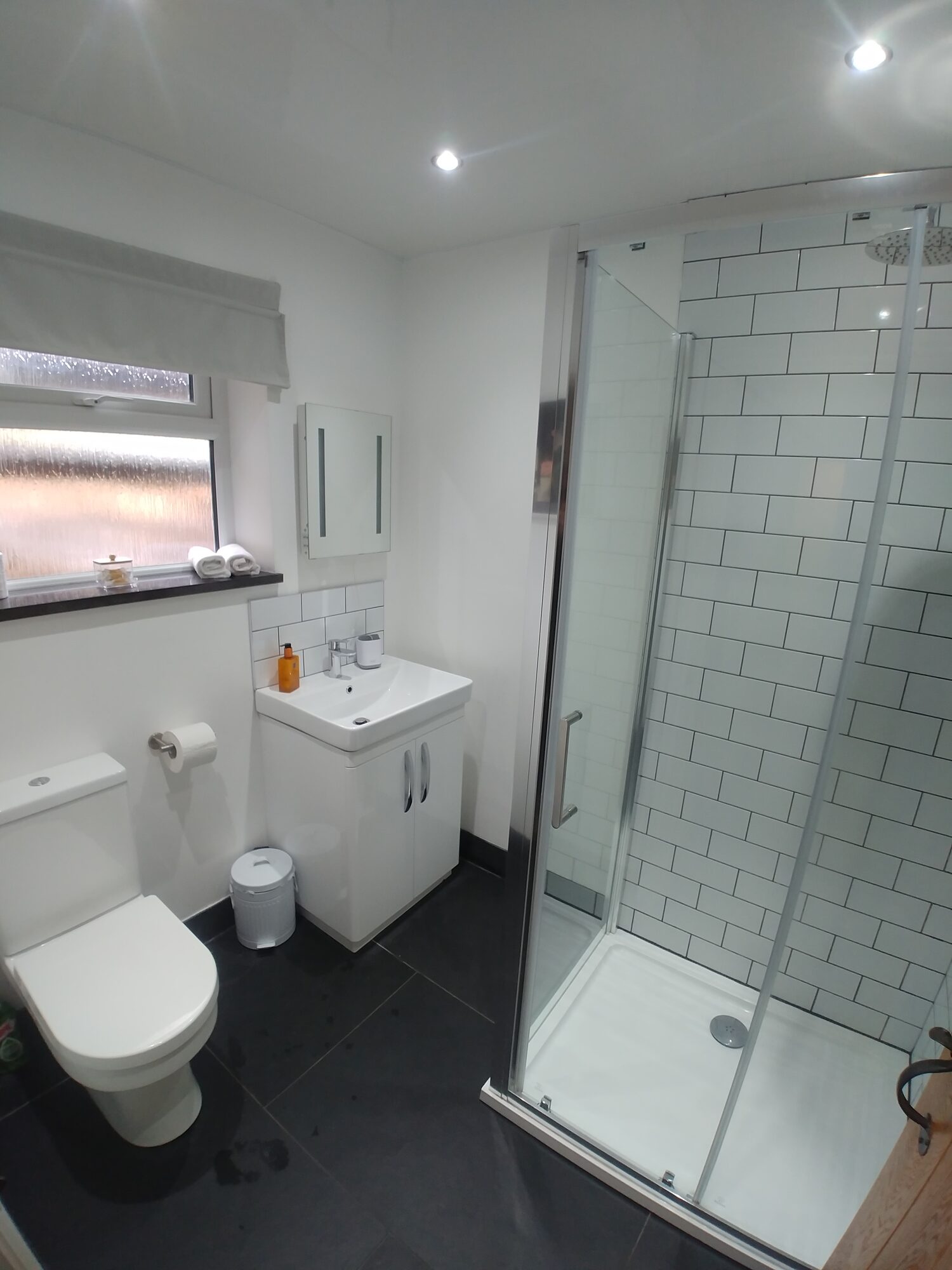 Bright modern shower room with brick tiles