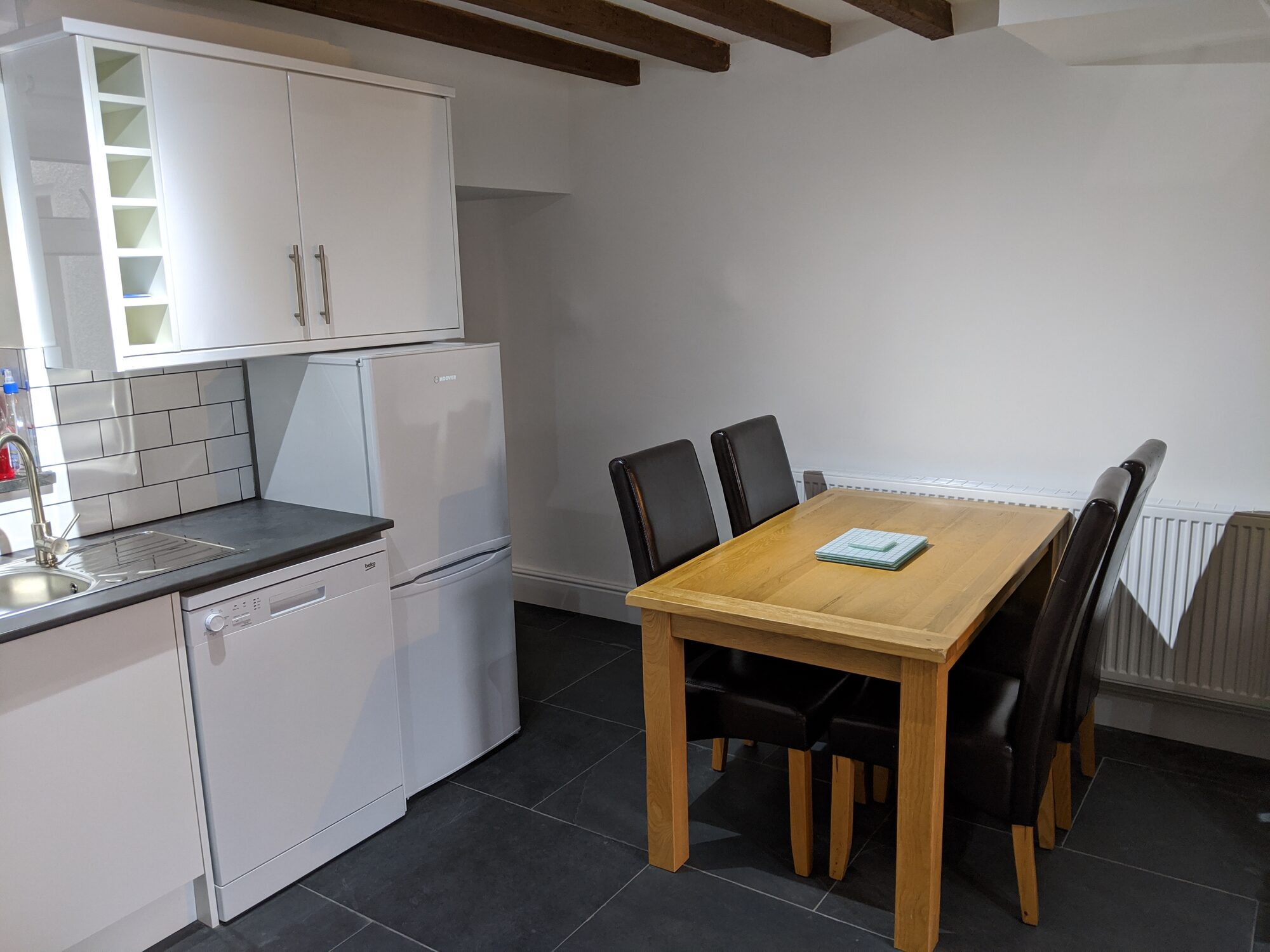 Dining area next to white open kitchen